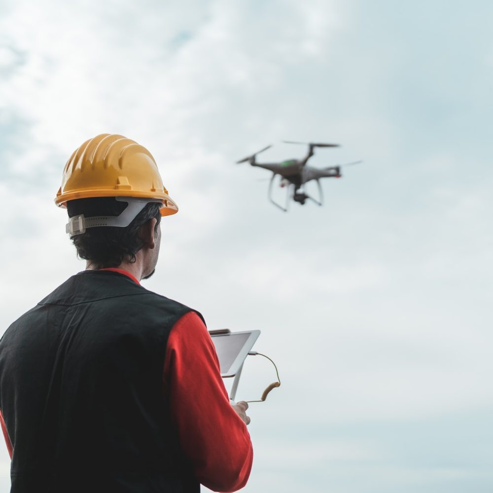 male-engineer-monitoring-construction-site-with-drone-technology-and-industrial-concept.jpg